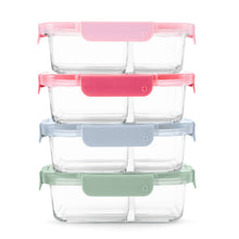 Stacked divided glass meal prep containers with pink, blue, and green lids