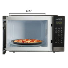 Countertop microwave with open door showing pizza on turntable