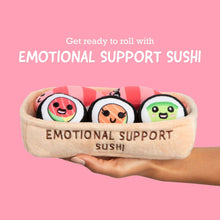 Plush sushi emotional support toy set in beige basket held by hand, five roll pals