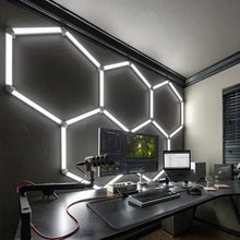 Hex ceiling light panels in an illuminated hex grid