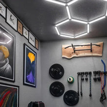 Hex ceiling light panels illuminating a ceiling hex grid