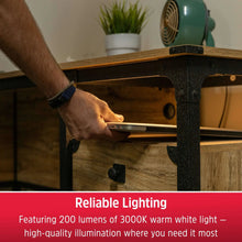 Rechargeable LED light bar inside cabinet, casting warm light on shelf