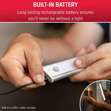 Rechargeable LED light bar being charged with USB cable, white housing