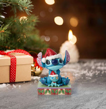 Blue Stitch stone-resin figurine with red Santa hat and stitched doll on decorated base