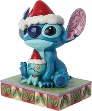 Blue Stitch stone-resin figurine with red Santa hat and stitched doll on decorated base