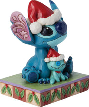 Blue Stitch stone-resin figurine with red Santa hat, stitched doll, and decorated base