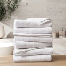 White bath towel set, folded stack of six plush towels
