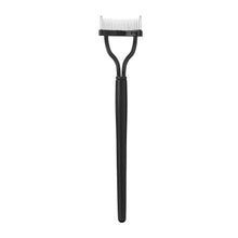 Black eyelash separator with curved handle and fine white comb teeth