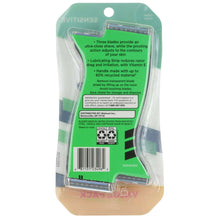 Disposable razor blister pack with green backing and clear plastic cover
