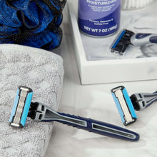 Men's disposable razor with blue handle and five blades on a folded towel