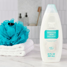 Sensitive skin body wash bottle with teal cap, 22 fl oz, upright on surface