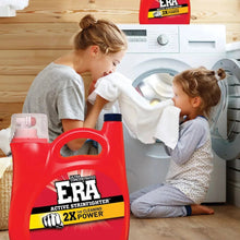 Laundry detergent jug near front-load washing machine with two people