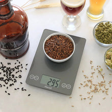 Digital kitchen scale with bowl of roasted beans on platform
