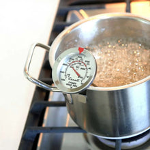 Cooking thermometer dial clipped to pot for monitoring temperature