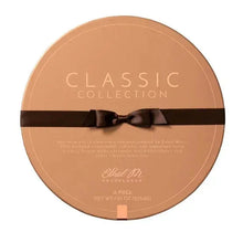 Round chocolate tin labeled Classic Collection with dark ribbon around the lid