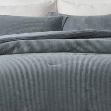 Close-up of blue mini waffle plush comforter and matching pillow texture