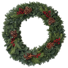 Evergreen wreath with red berries, cedar sprigs, and pine cones