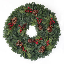 Evergreen wreath with fir and cedar branches, red berries, and pine cones