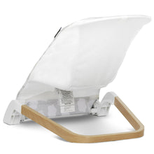Light gray portable infant bouncer with white canopy cover and cloud-print breathable fabric