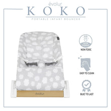 Portable infant bouncer, light gray cloud-pattern seat on white frame with wood base