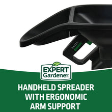Black handheld broadcast spreader with ergonomic arm support and thumb lever