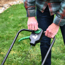 Green-and-black spreader handle control with arrow switch and attached cable