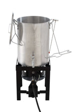 Aluminum turkey fryer pot with spigot and side handles on black stand