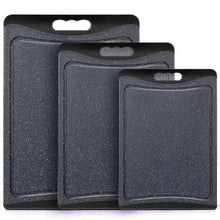 Dark grey plastic cutting board set of 3 with hanging holes, speckled surface.