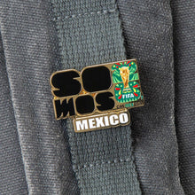 Enamel lapel pin featuring FIFA logo and Mexico flag design on gray fabric