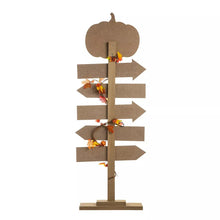 Wooden pumpkin patch arrow sign on a base with leaf garland accents on the post