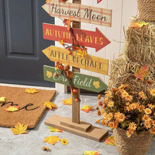 Wooden fall pumpkin patch porch sign with colorful arrow banners and autumn garland