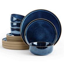 Midnight blue stoneware dinnerware set with stacked plates and cereal bowls, gold-trim rims