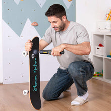 Electric screwdriver tightening hardware on a black skateboard deck