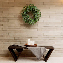 Faux eucalyptus wreath with small green leaf clusters forming a full circle.