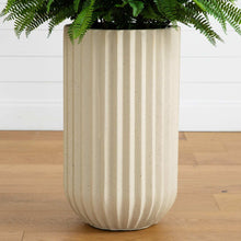 Beige ribbed planter with green faux fern