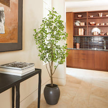 Potted faux ficus tree with green leaves in a dark ceramic pot