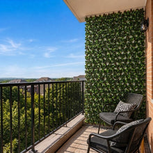 Faux gardenia hedge trellis covering a balcony wall with dense green foliage