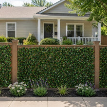 Faux gardenia trellis covering a wooden fence with dense green leaves