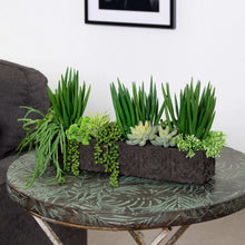 Faux succulent planter arrangement in dark textured planter with pale rosette and spiky greens