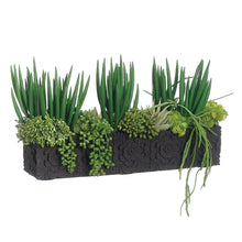 Faux succulent planter arrangement in black cement container with upright grasslike leaves