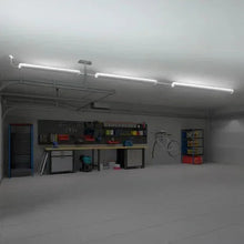 Ceiling-installed multi-directional shop lights with white housings, lights on