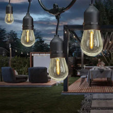 LED string lights with dark cord and glowing clear bulbs outdoors