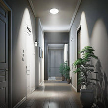 Round ceiling fixture with frosted diffuser glowing softly for night light