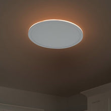 Round ceiling fixture with frosted diffuser lit with warm night glow