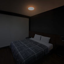 Round ceiling fixture with frosted diffuser showing a soft warm glow
