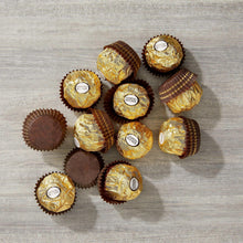 Ferrero Rocher candies with gold and brown wrappers arranged in a scattered layout