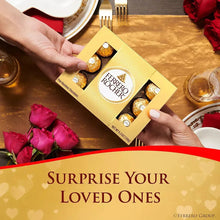 Ferrero Rocher chocolate gift box held by hands with chocolates beside
