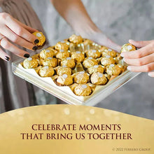Ferrero Rocher chocolates in a tray held by hands for serving