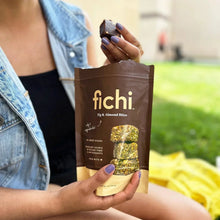 Person holding a fig and almond bites pouch
