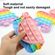Triangle fidget pop it toy with pastel pink bubbles held by a hand